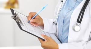 A scientist taking notes on her checklist