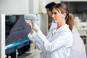 Woman scientist observing her test samples