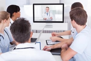 Scientist in an online meeting with doctor on screen