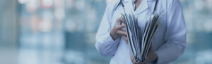 Photo of a woman holding several documents